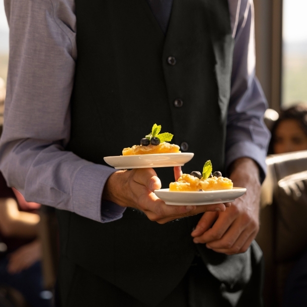 Host bringing snacks to guests