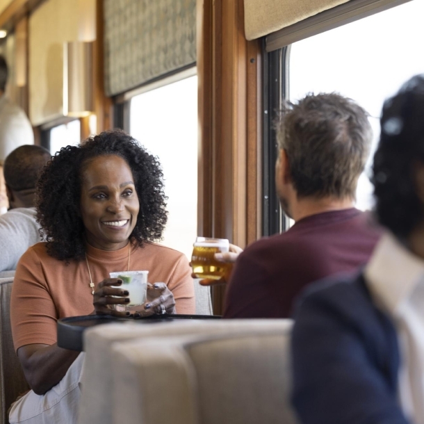 Guest enjoying a drink in the lounge car