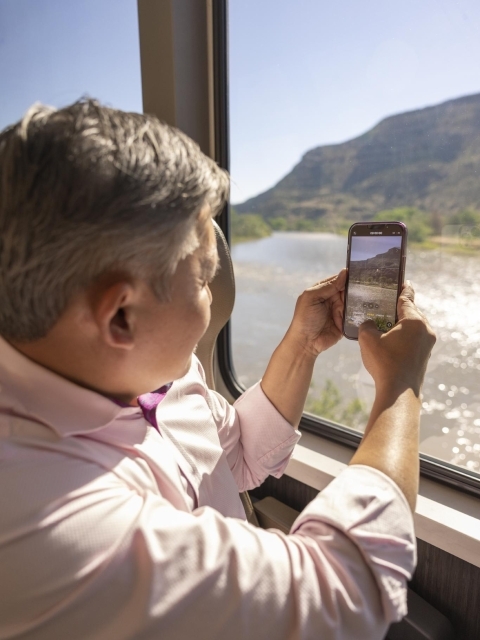 Guest taking a picture on their phone of the Canyons