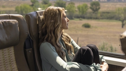 Tourist looking out the window from Canyon Spirit