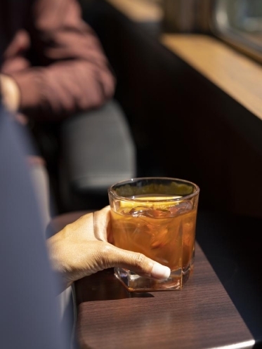 A guest holding a drink in their hand.